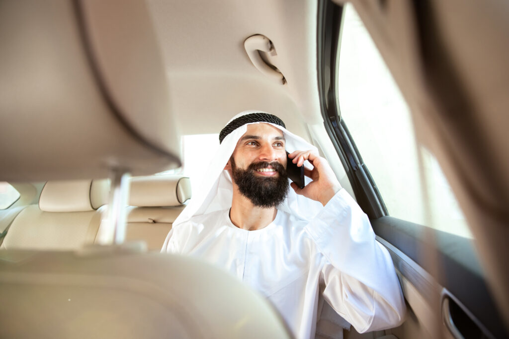 Arabian saudi businessman working in his car